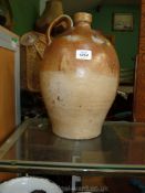 A large 18th c. salt glaze stoneware Bottle, (the buff body with mottled brown dip), 14" high.