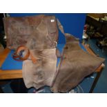 A pair of Vale of Belvoir chaps and a saddle bag marked G.