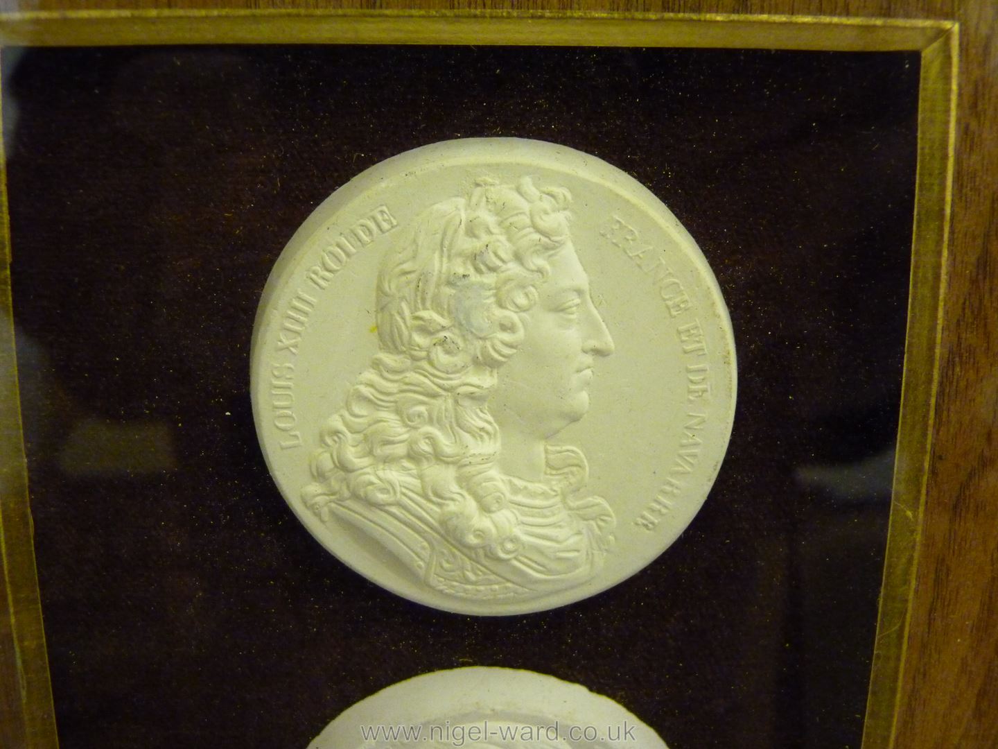 A framed small group of classical plaster cast medallions. - Image 3 of 7