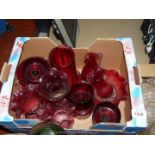 A quantity of cranberry glass including vases, jugs,