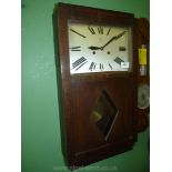 An Oak cased art deco design Wall Clock by Junghans having a rectangular face with Roman numerals