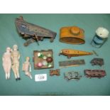 A box of early dolls and tinplate German and other toys and a tin in the form of a WWI tank.