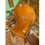 An Oak Monks Seat/Armchair having a solid seat turned legs and arm supports,