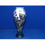 A large Moorcroft tube lined Vase having a naturalistic bulbous body decorated with stylised