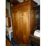 A mixed woods Armoire/Cupboard having opposing double doors,