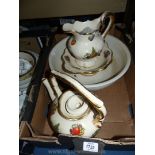 A large Teapot decorated with fruits and gold edging and matching jug and dish plus one large cream