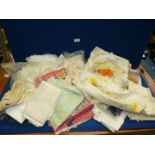 A quantity of linen including tablecloths, napkins, embroidered table line etc.