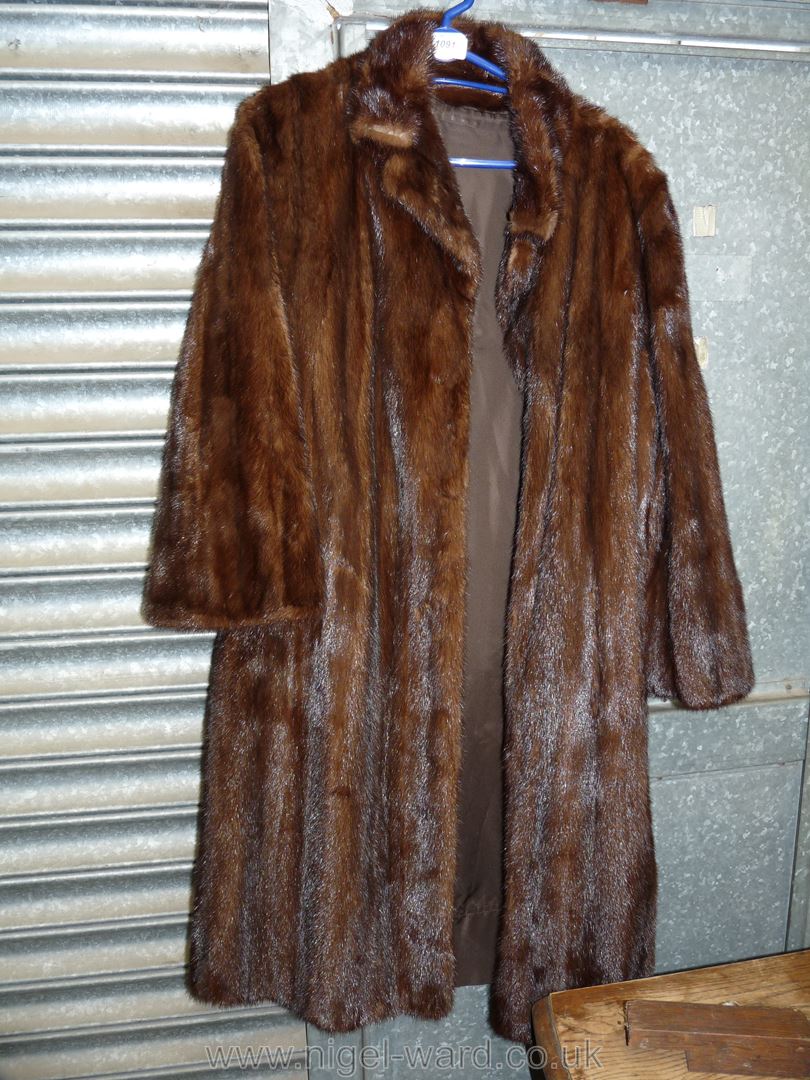 A Fur coat with three quarter length sleeves, size M/L.