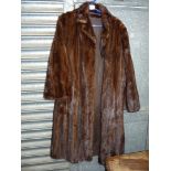 A Fur coat with three quarter length sleeves, size M/L.
