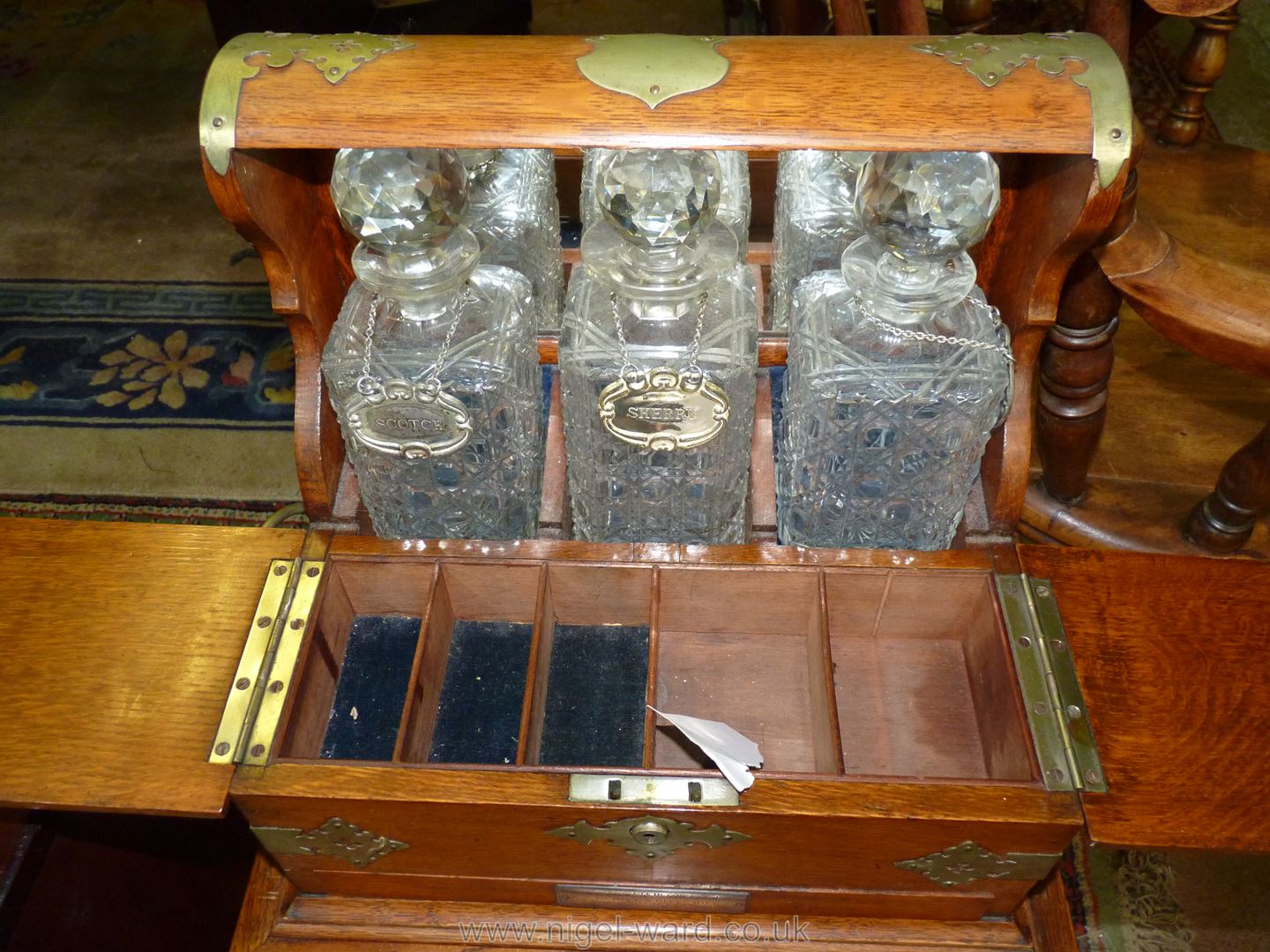 A good Oak three decanter Tantalus on a stand, mirror backed with brass fittings and carry handles. - Image 4 of 6