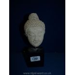 A vintage composition Head of The Buddha on a stand, 9" tall.