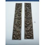 A pair of oak frieze Panels, each carved with a central gowned figure among foliage and birds,