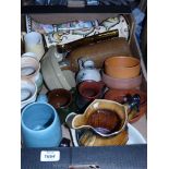 A box of pottery to include Wade multi coloured jug, stoneware bottle, Cornish pottery vases,