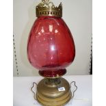 A Victorian church Oil/heater Lamp with squat brass fount standing on three squat feet,