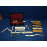 A Mahogany box and contents of draughtsman equipment including compasses, rulers, slide rules,
