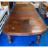 A mixed woods circa 1900 wind-out Dining Table standing on heavy turned and fluted legs,