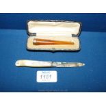 A cased 9ct gold and Amber cheroot holder and a silver bladed, mother of pearl handled Fruit Knife,