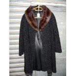 A faux fur lamb cut Coat, size 12, three quarter length.