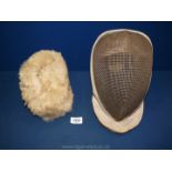 A Fencing mask and Russian fur hat.