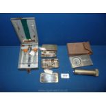 A box of medical instruments including syringes, (some metal cased), etc.