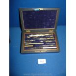 A Rosewood cased box of vintage brass and ivory draughtsman's Drawing Instruments with protractors,