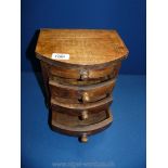 A small Oak bow fronted jewellery Chest of four drawers, 10'' x 9'' x 7''.