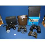 A boxed and cased pair of Regent 10 x 50 binoculars, cased Carlton 12 x 50 binoculars,