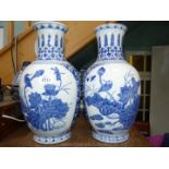 A pair of blue and white vases decorated with flowers and kingfishers, 14 1/2'' tall.