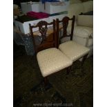 A pair of Edwardian Mahogany framed side Chairs having floral and swag carved detailed backs,