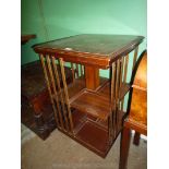 A Mahogany revolving Bookcase/Table having light and darkwood stringing and cross banding to the