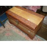 A profusely carved Camphorwood Chest having sliding internal compartment/tray,