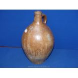 A large 17th century German stoneware flask stamped to the neck with four acorn crests,