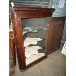 A Georgian dark Oak wall-hanging Corner Cupboard having a recessed shaped panelled door,