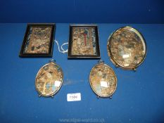 Five small oriental embroideries in oval and square frames, from 4 1/4'' to 7'' tall.