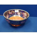 A Maling Newcastle-on-Tyne Lustre Bowl with mottled red and orange centre and a dark purple with