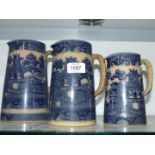 A graduated set of Doulton Burslem willow pattern jugs, smallest with handle repair,