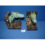 A pair of marble harnessed horse head bookends