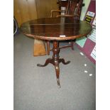 A dark Oak Snap-top occasional table standing on a turned pillar with elegant splay feet.