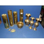 A box of brass including; four large shell cases, a pair of matching vases with fluted rims, etc.