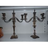 A pair of heavy plated Candelabra (that convert to single candlesticks) with stoppers,