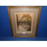 A framed and mounted pencil signed coloured Etching, indistinct signature, Belgian water way.