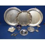 A quantity of white metal items to include; two serving trays on feet, a sugar bowl with blue liner,