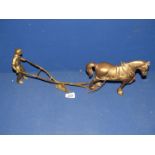 A brass ploughman with heavy horse and plough