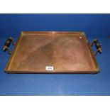 A rectangular Copper tray with turned wooden handles, 18 1/2'' x 13 1/2''.