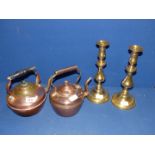 Two copper kettles and two push-up Candlesticks.