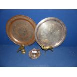 A brass and copper Charger with animal decoration to centre and scroll decoration to rim,