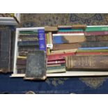 A white drawer of Bibles and other Religious themed books.