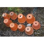 Nine mixed terracotta flower pots.