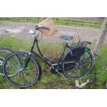 A Cumberland Classic bicycle with dynamo and wicker carrying basket.