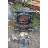 A cast iron fire with grate and accessories, 29" wide x 19" deep x 41" high.